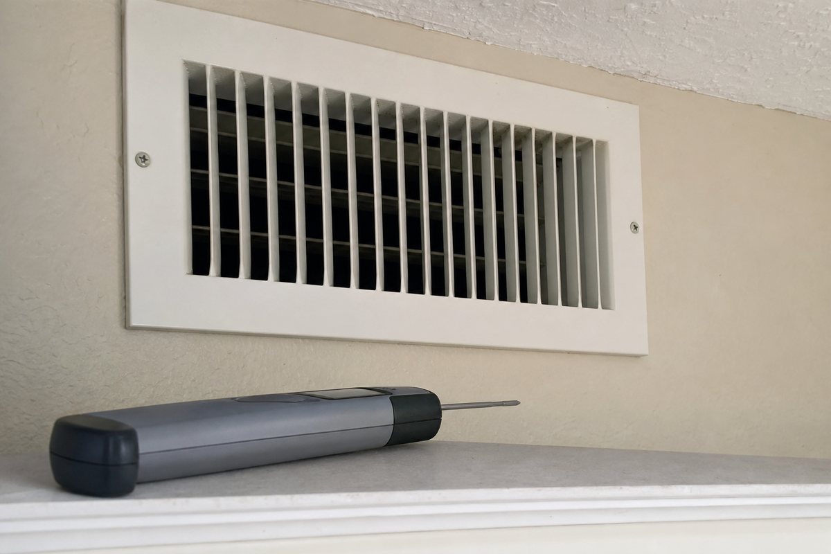 Florida homeowner checking AC return and supply temperature split in a home