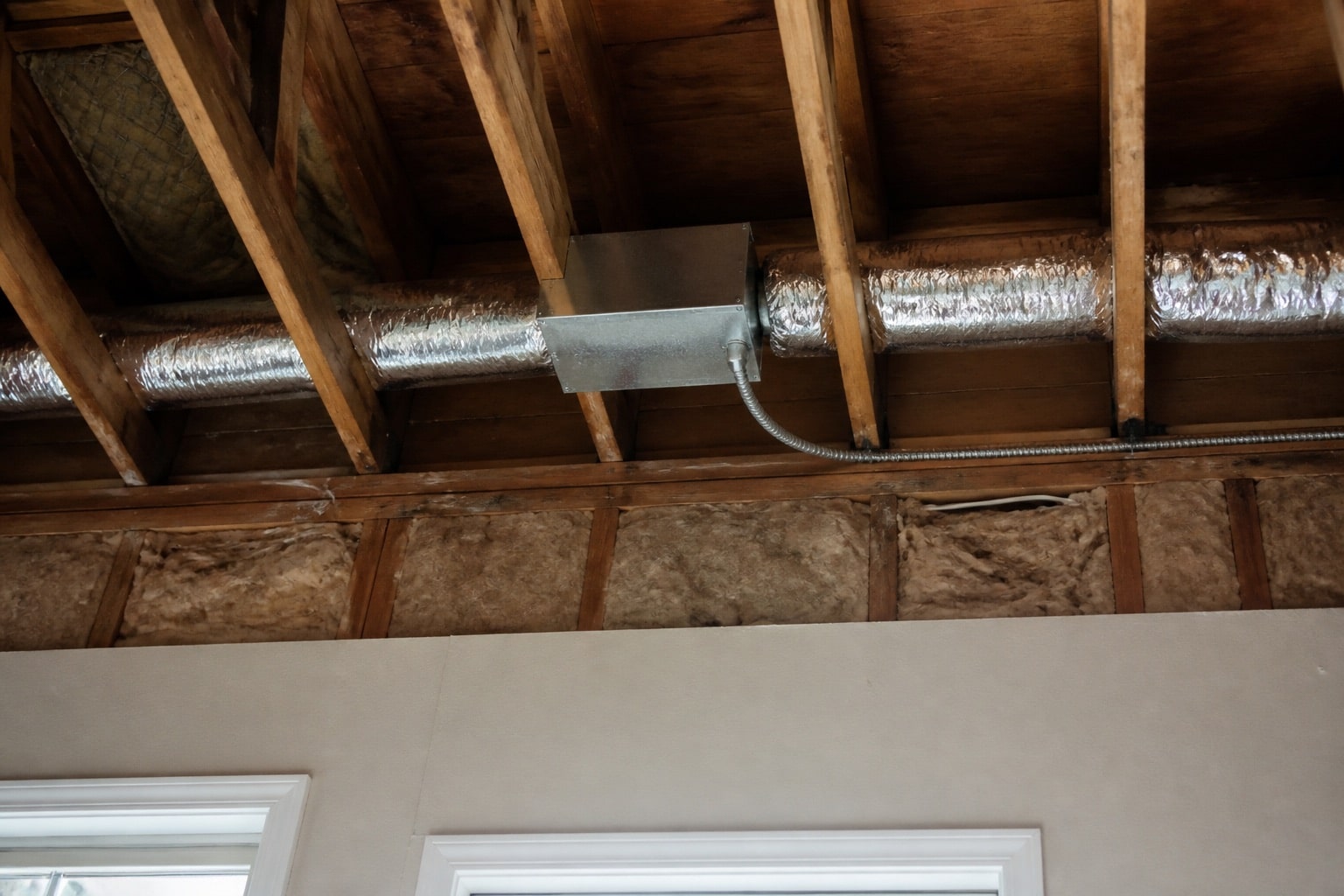Insulated makeup air duct with a motorized damper routed above a Florida kitchen ceiling