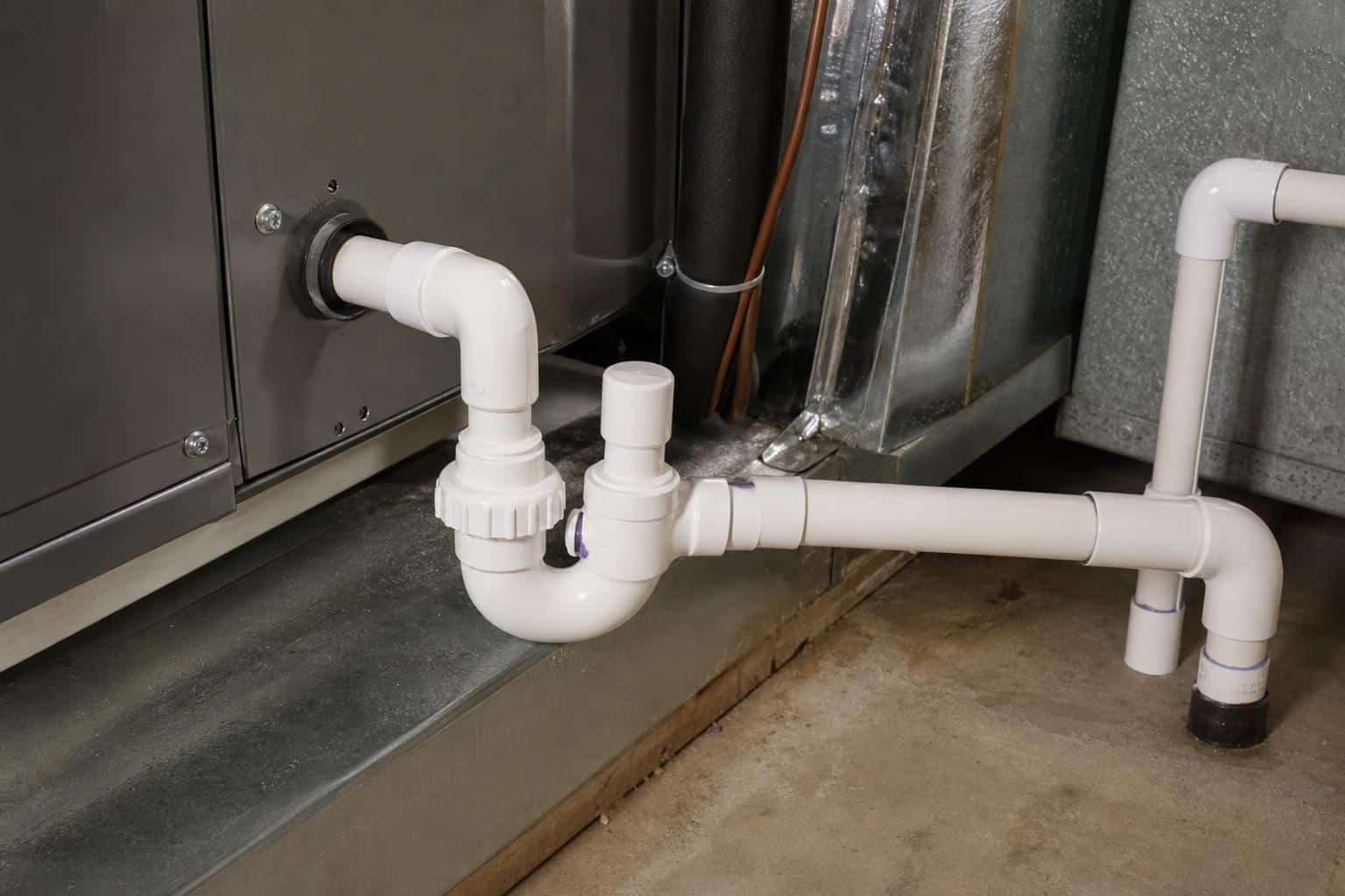 Residential air handler condensate trap and PVC drain line connection