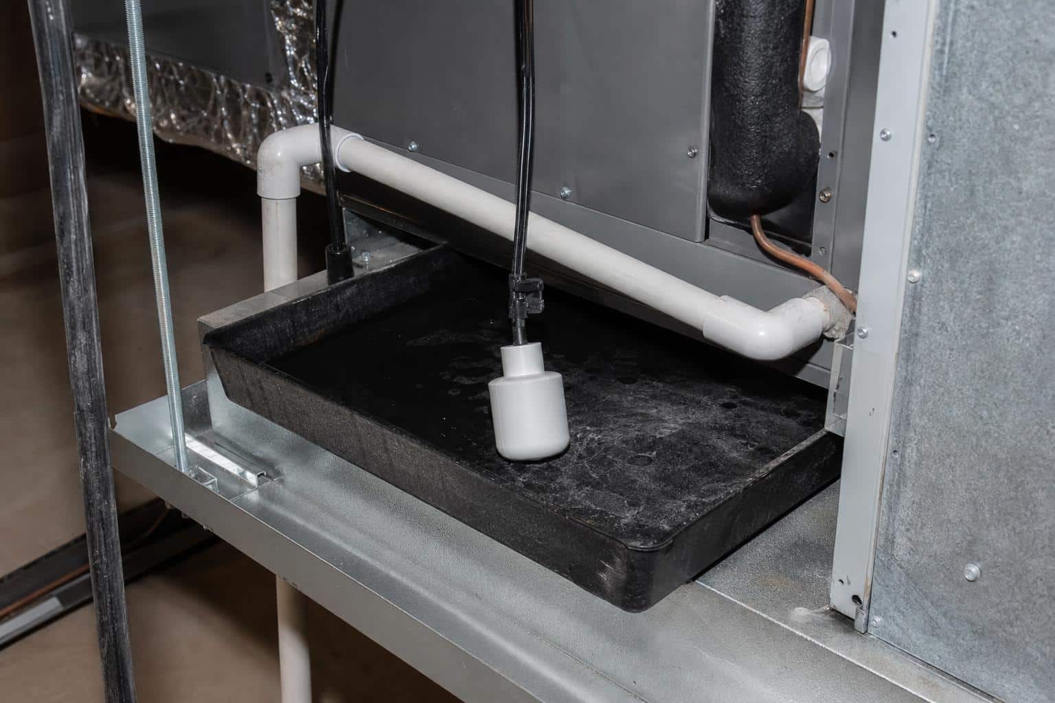 Float switch in air handler secondary drain pan indicating water backup