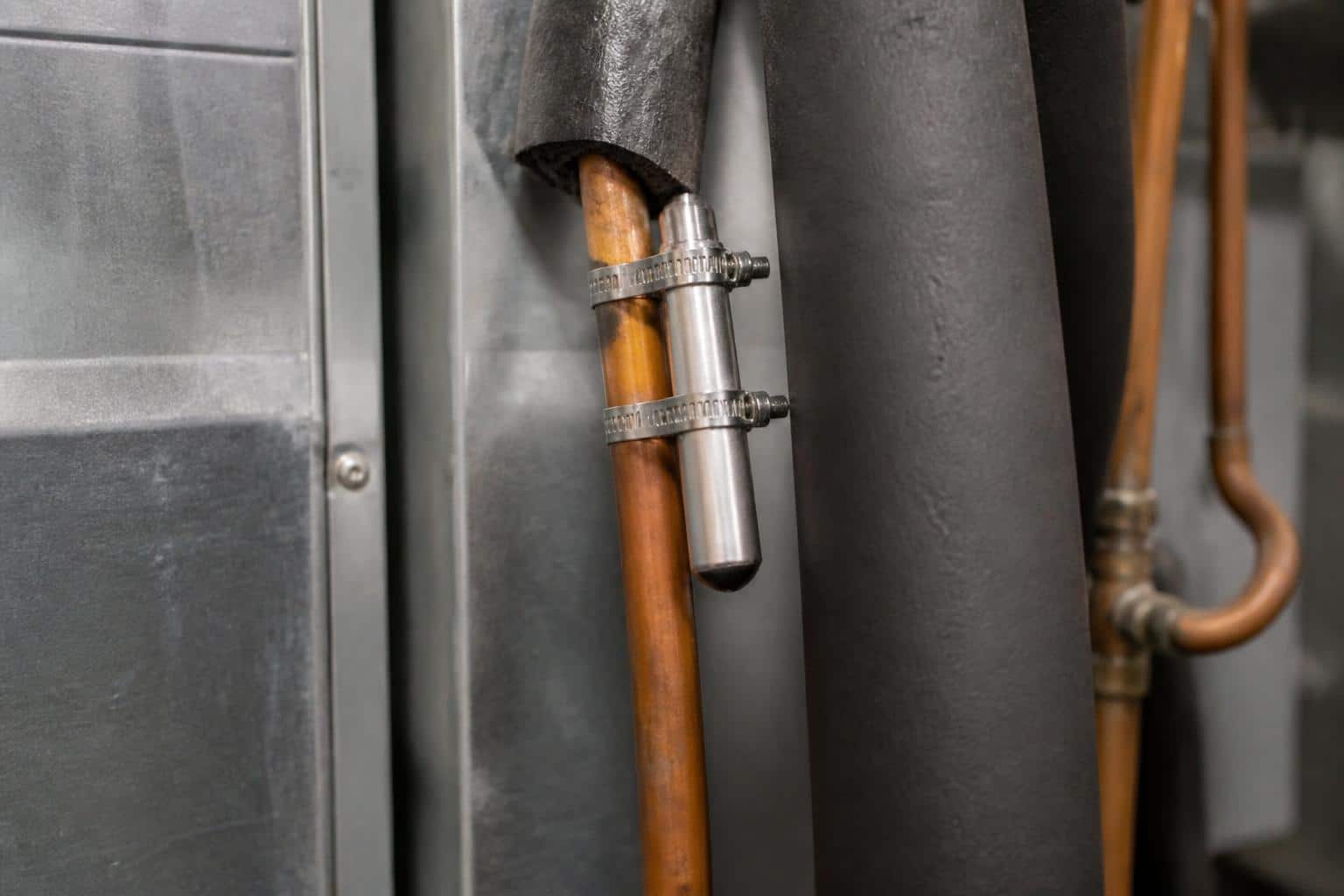 Thermostatic expansion valve with sensing bulb mounted at the evaporator coil inlet of an air handler