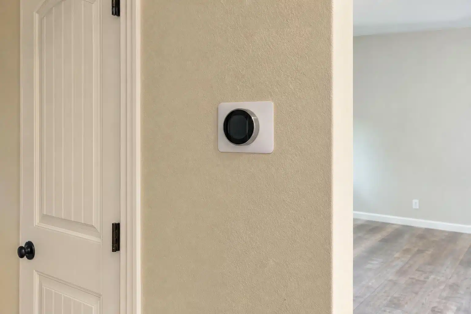 Thermostat mounted on a central interior wall in a Florida home hallway