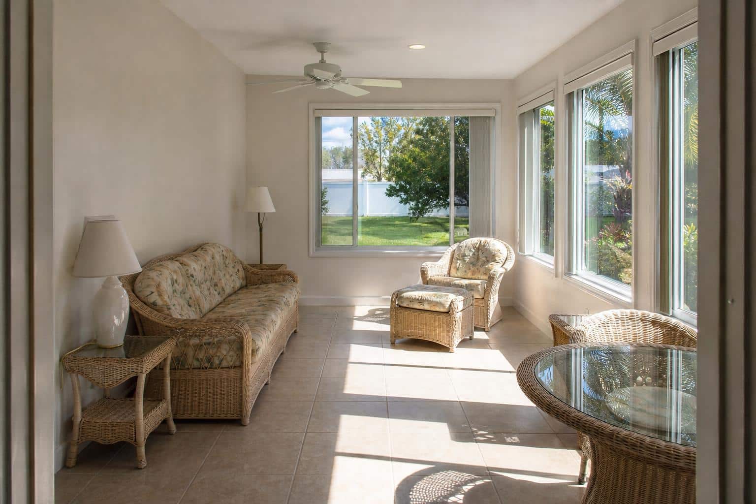Florida room sunroom with bright sunlight streaming through windows
