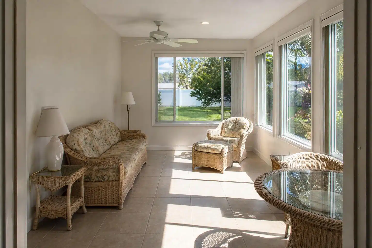 Florida room sunroom with bright sunlight streaming through windows