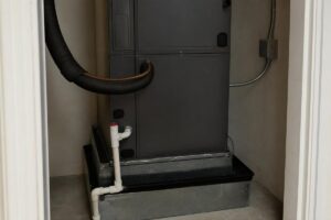 Air handler above an auxiliary condensate pan